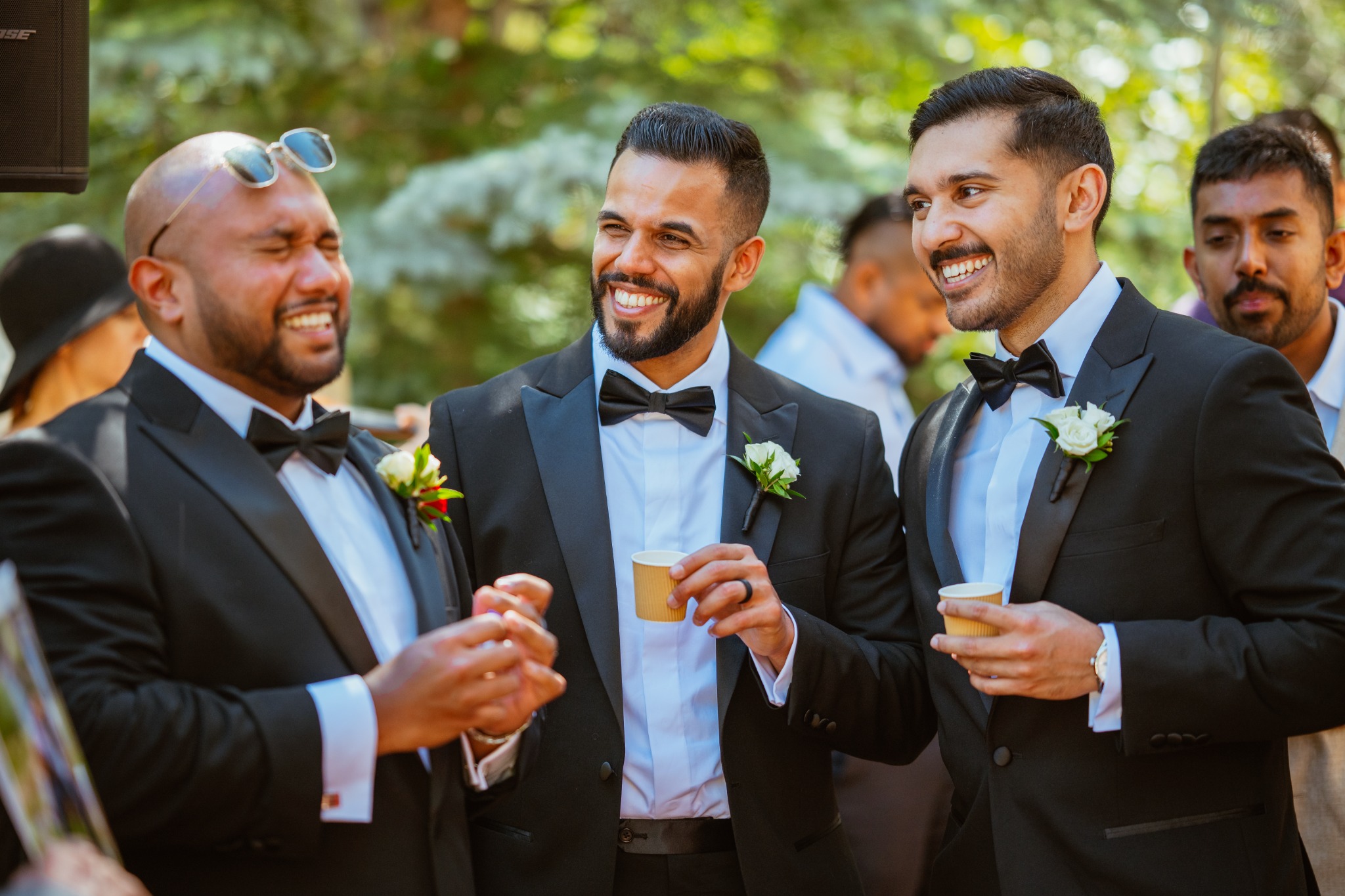 Groom and friends laughing together during the wedding day