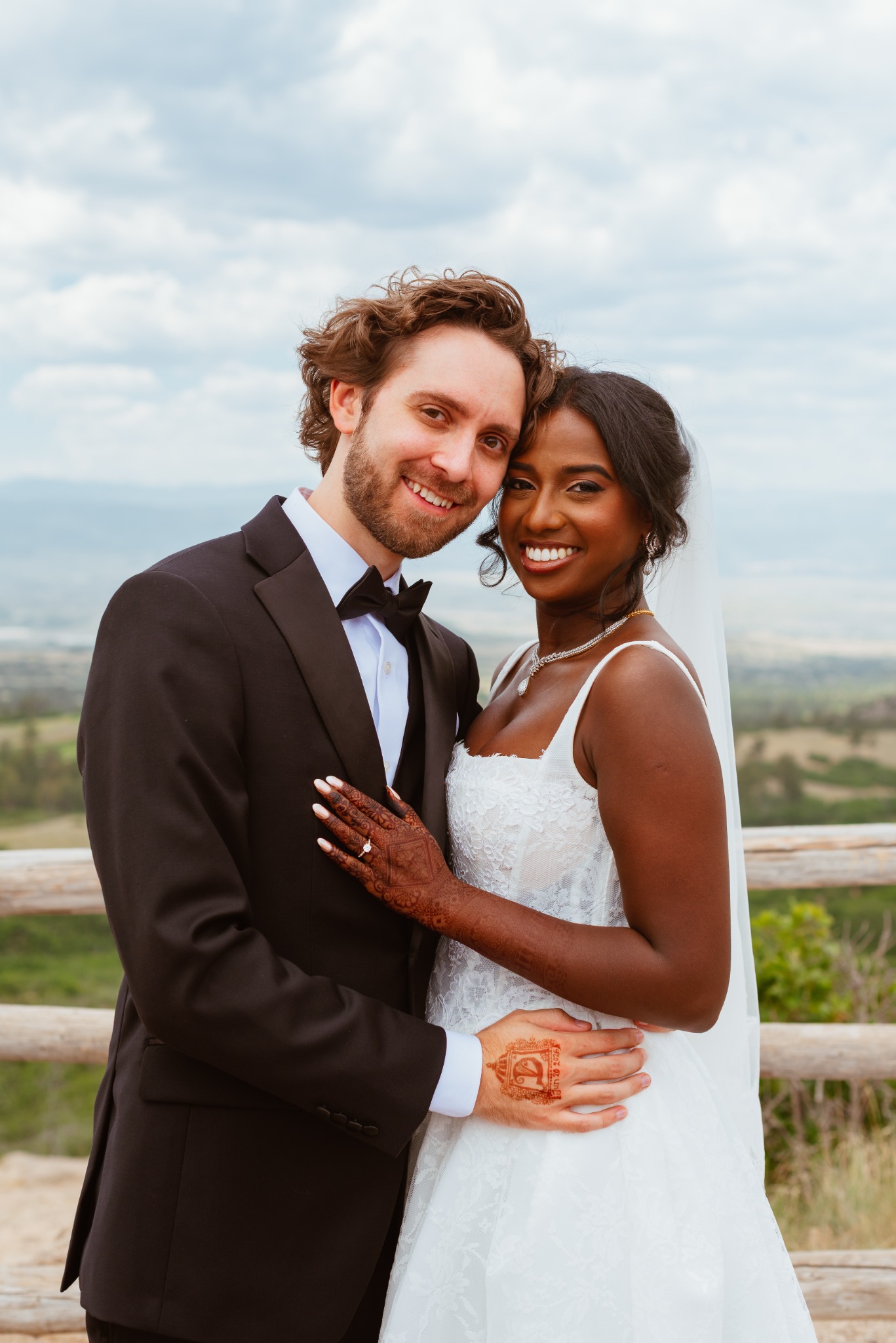 Wedding couple sharing a relaxed portrait outdoors